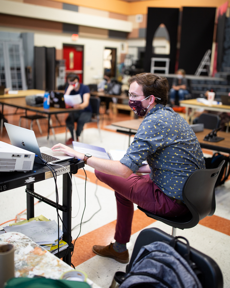 Person using laptop in classroom setting