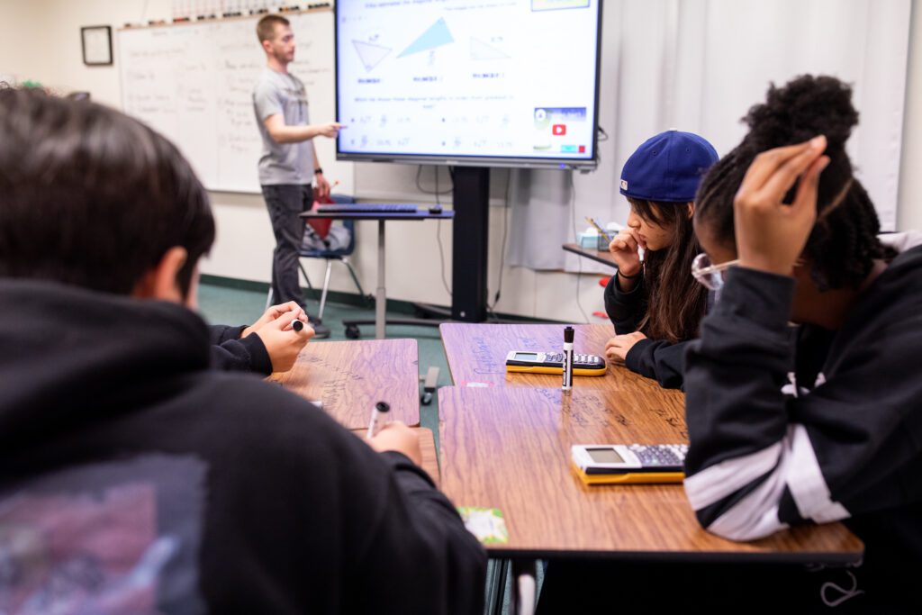 Teacher in front of classroom at Texas middle school. 