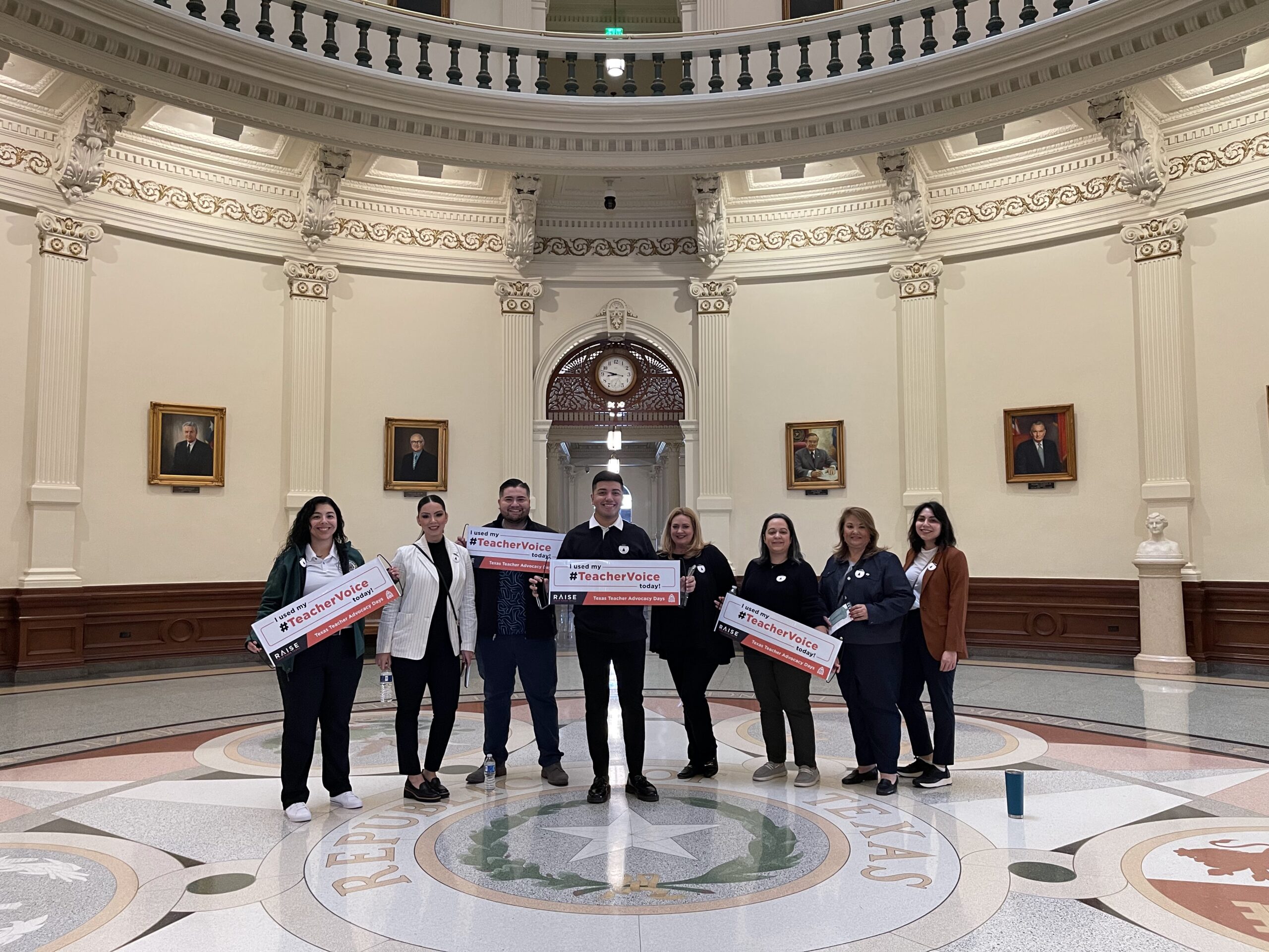 Teachers visiting the Capitol, standing in the rotunda, celebrating advocacy.