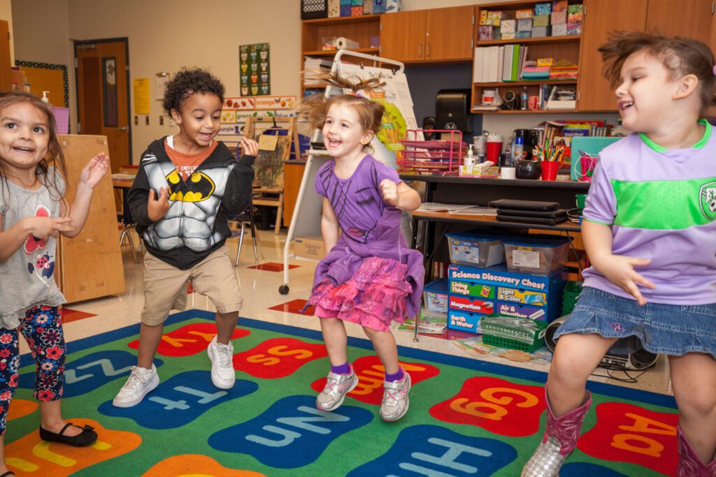 Pre-k students jumping around in their classroom.